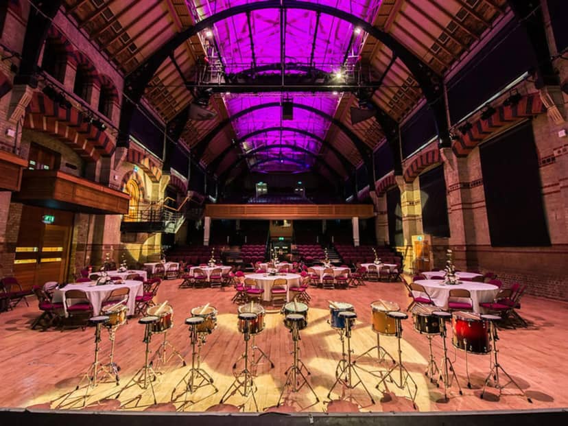 Cambridge Corn Exchange auditorium with creative lighting for themed gala and corporate dinner.