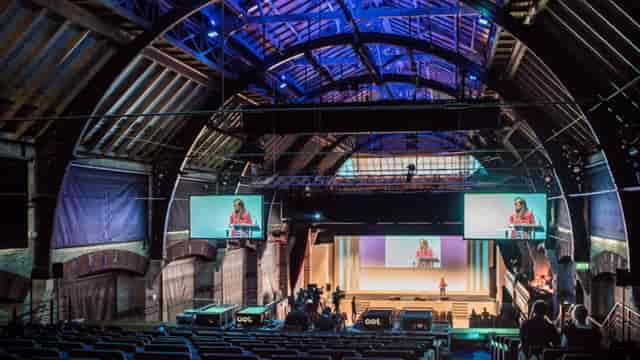Cambridge Corn Exchange auditorium with AV production for theater-style corporate events.