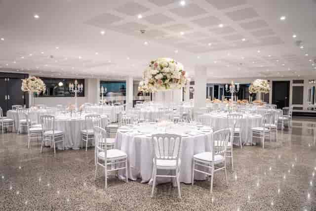 Elegant banquet space at Le Jardin, ideal for weddings and corporate events with floral centerpieces.
