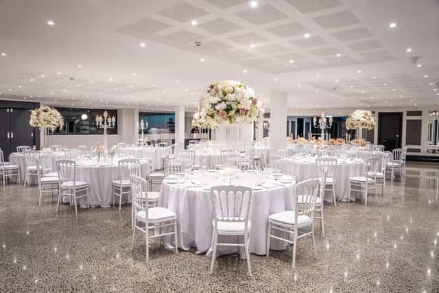 Elegant banquet space at Le Jardin, ideal for weddings and corporate events with floral centerpieces.