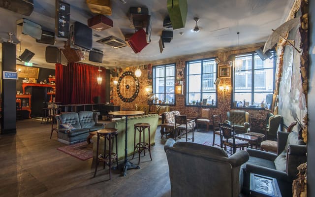 Eclectic Lower Level Bar breakout space with unique suitcase lighting for VIP events.