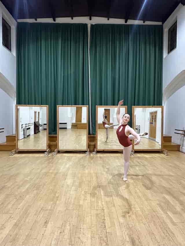 Upper Hall studio with stage for wellness workshops and small-scale performances.