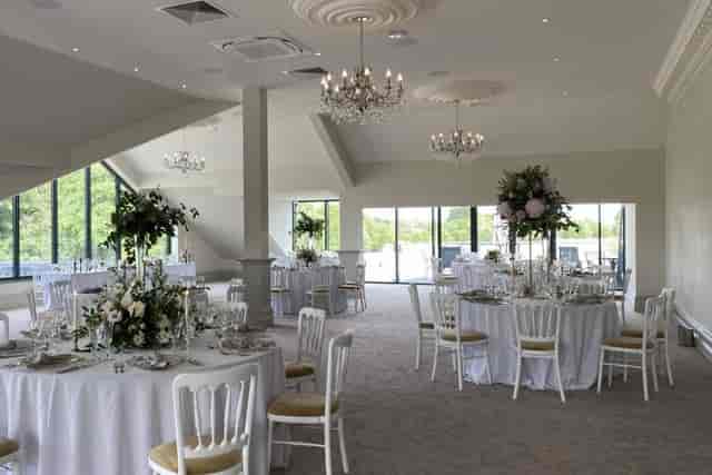 Elegant Royal Suite ballroom with floral centerpieces for luxury wedding and gala events.