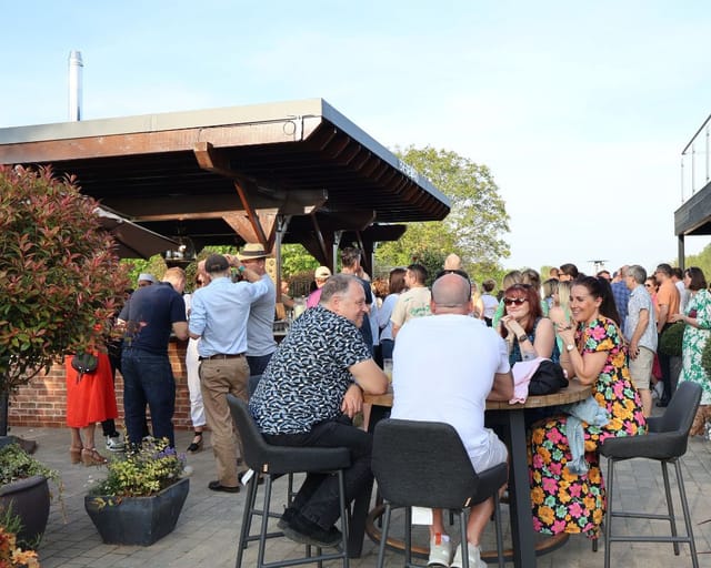 Networking reception on The Terrace at Cambridge Country Club with high-top seating.