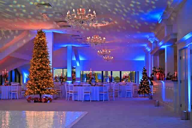 The Terrace ballroom at Cambridge Country Club with festive gala lighting and holiday decor.