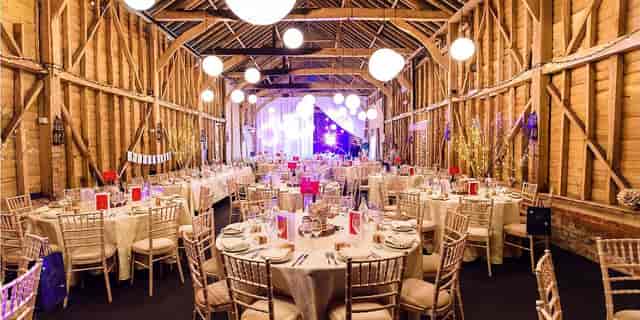 Rustic-chic barn wedding venue at Childerley Hall featuring ambient globe lighting.