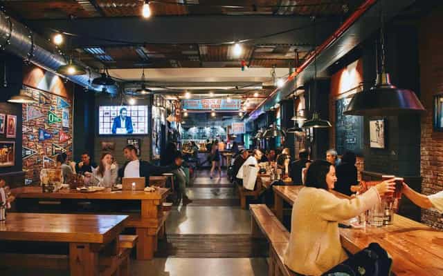 Communal tables at CocoVail Beer Hall, ideal for team-building events and networking venues.