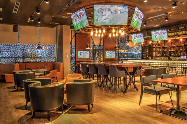 Modern dining room in sports bar, versatile space for events and presentations.