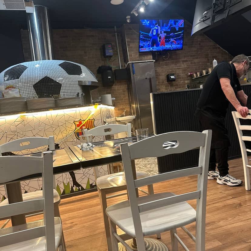 Cozy Sports Bar Italian dining room with soccer ball decor, perfect for watch parties.