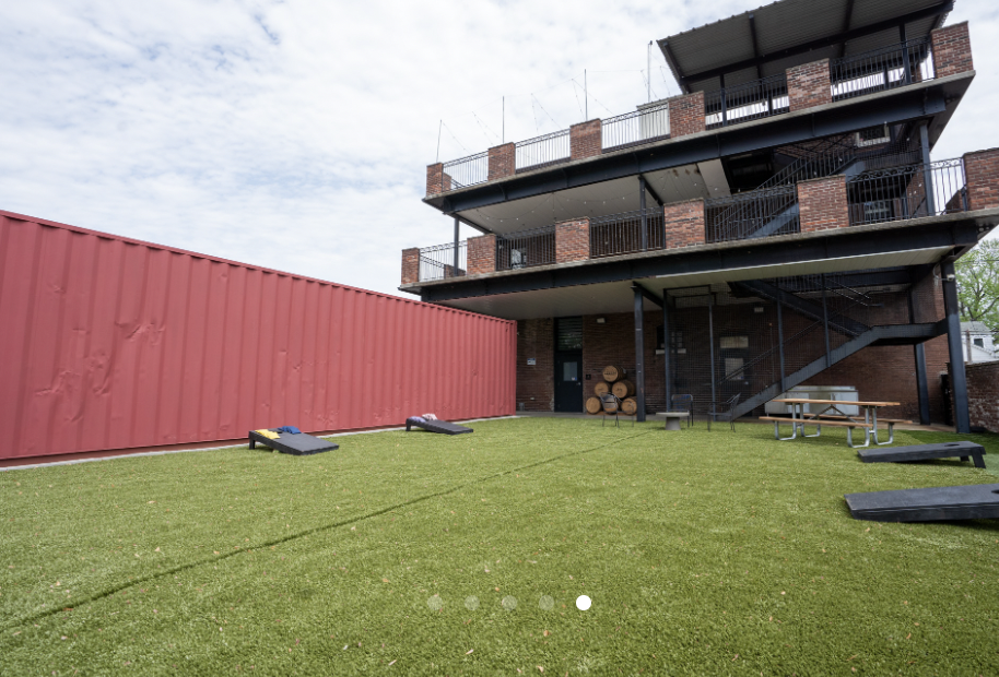 Outdoor venue with artificial grass for group events at Swepson Guesthouse.