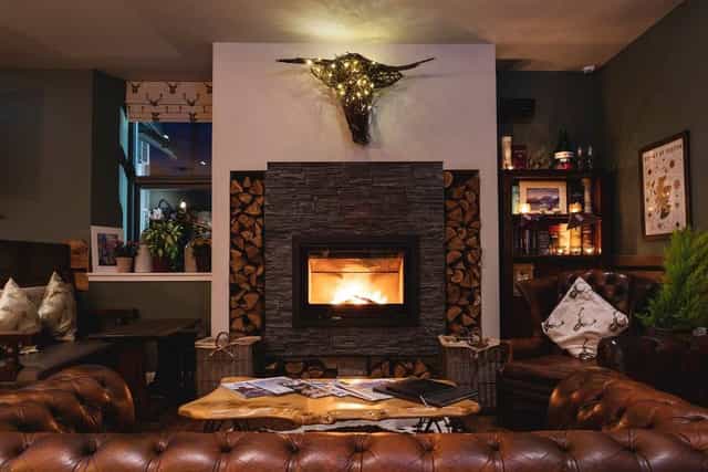 Cozy lounge with fireplace at Ben Cruachan Inn, ideal for gatherings and retreats.