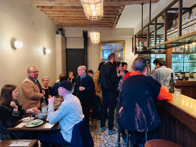Vibrant networking event at Le Grand Bain with communal seating promoting conversation.