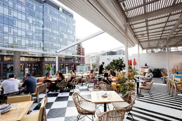 "Portland Room rooftop dining space with modern decor for networking events and gatherings"