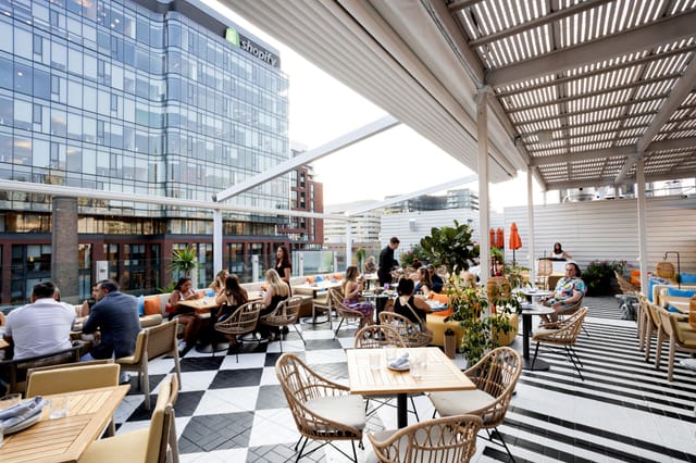 "Portland Room rooftop dining space with modern decor for networking events and gatherings"