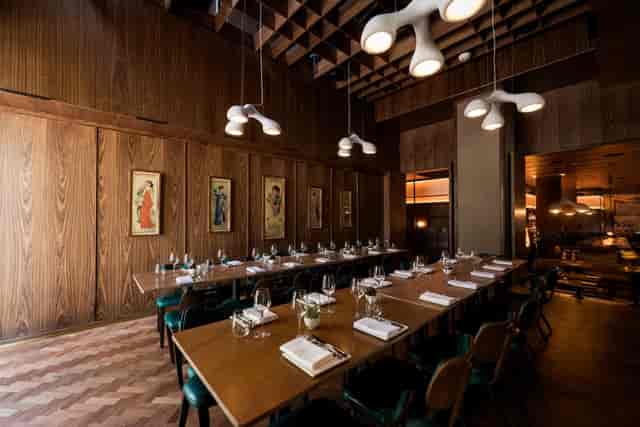 Upscale private dining room with statement lighting for executive dinners and networking events.