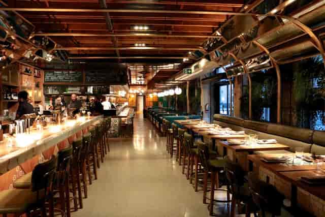 Modern bar interior with warm lighting, perfect for private dinners and networking events.