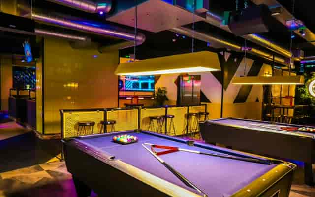 Vibrant event space with stylish pool tables in King Pins, ideal for networking and team-building.
