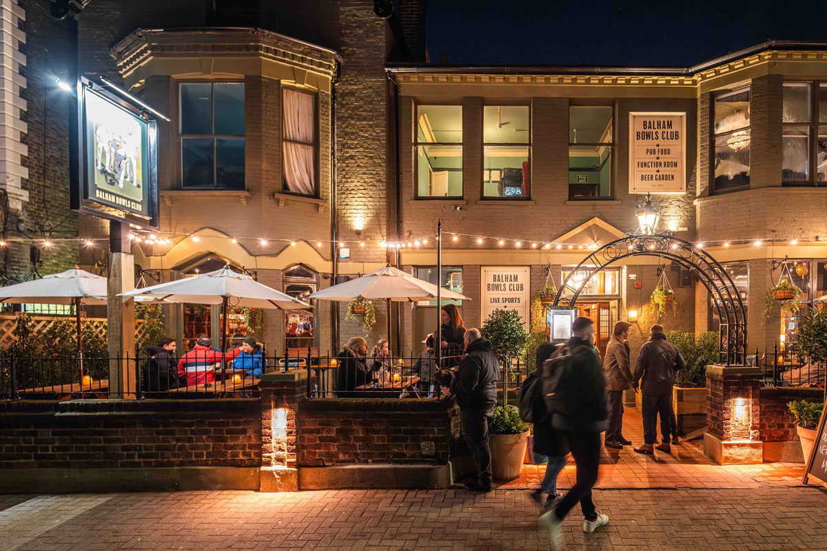 Charming Balham Bowls Club Lounge with cozy outdoor seating for events and receptions.