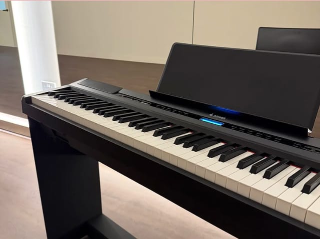 Sleek digital piano in Tails Studio for sophisticated event ambiance and live entertainment.