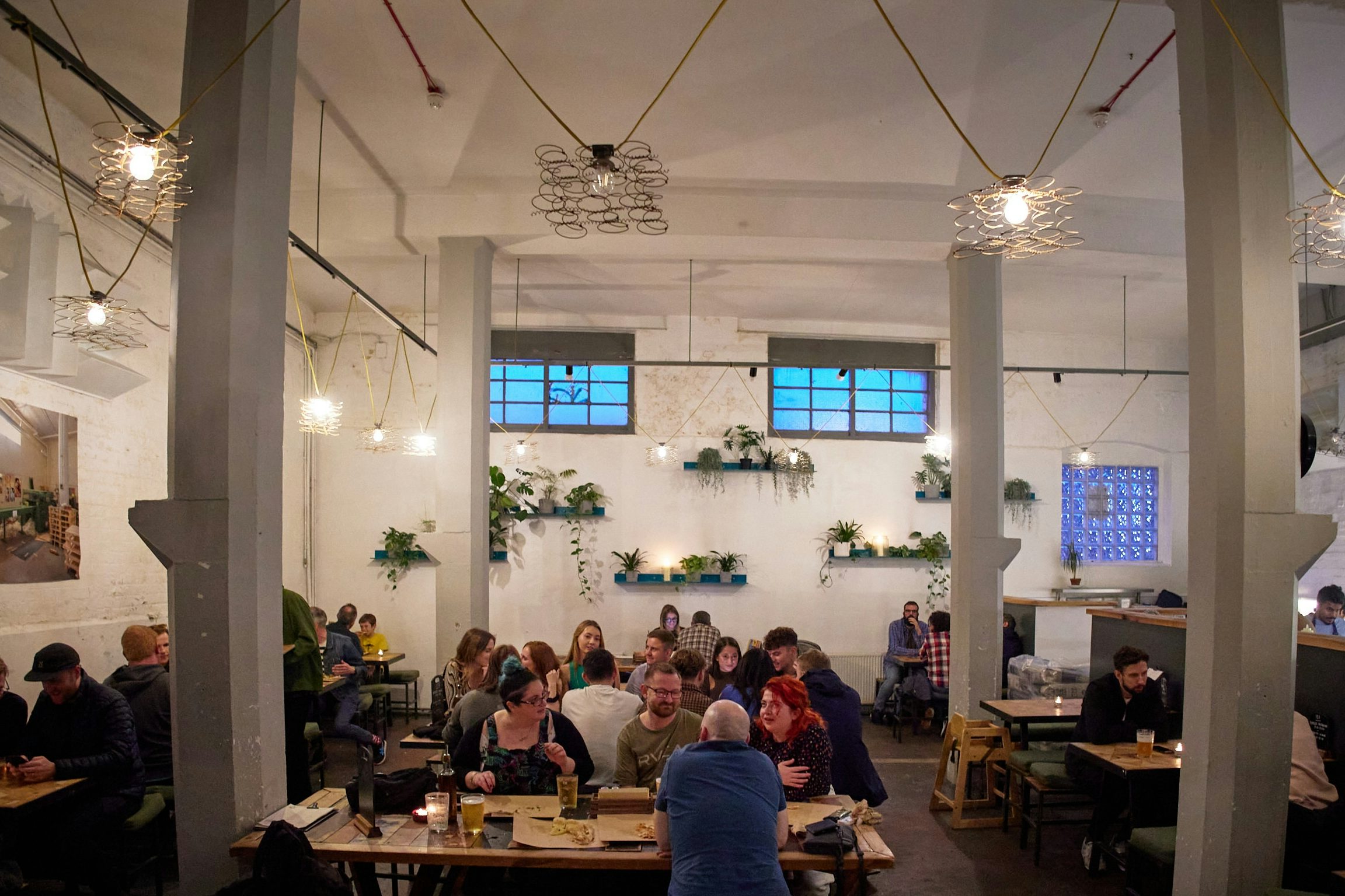 Industrial-chic CRATE Brewery venue with high ceilings for team-building and networking events.