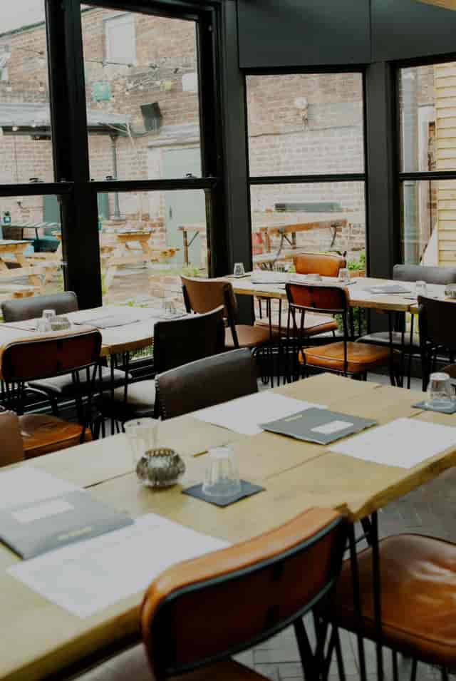 Stylish meeting space for corporate events with wooden tables and natural light.
