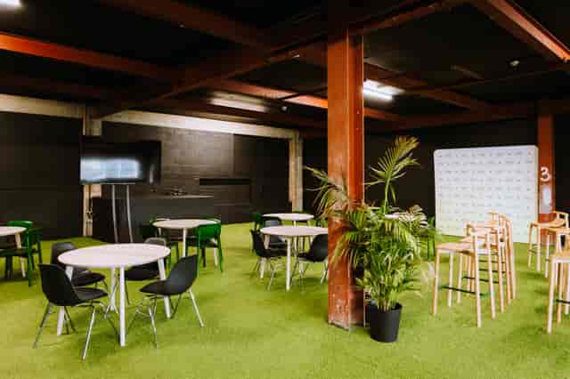 Industrial-chic breakout loft with turf floor for modern networking events and workshops.