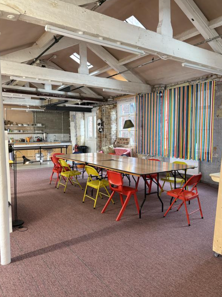 Versatile venue hire in From the Other studio with colorful chairs for creative workshops.