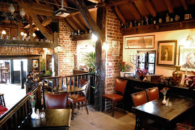 Rustic dining room with exposed brick, perfect for intimate gatherings and corporate events.