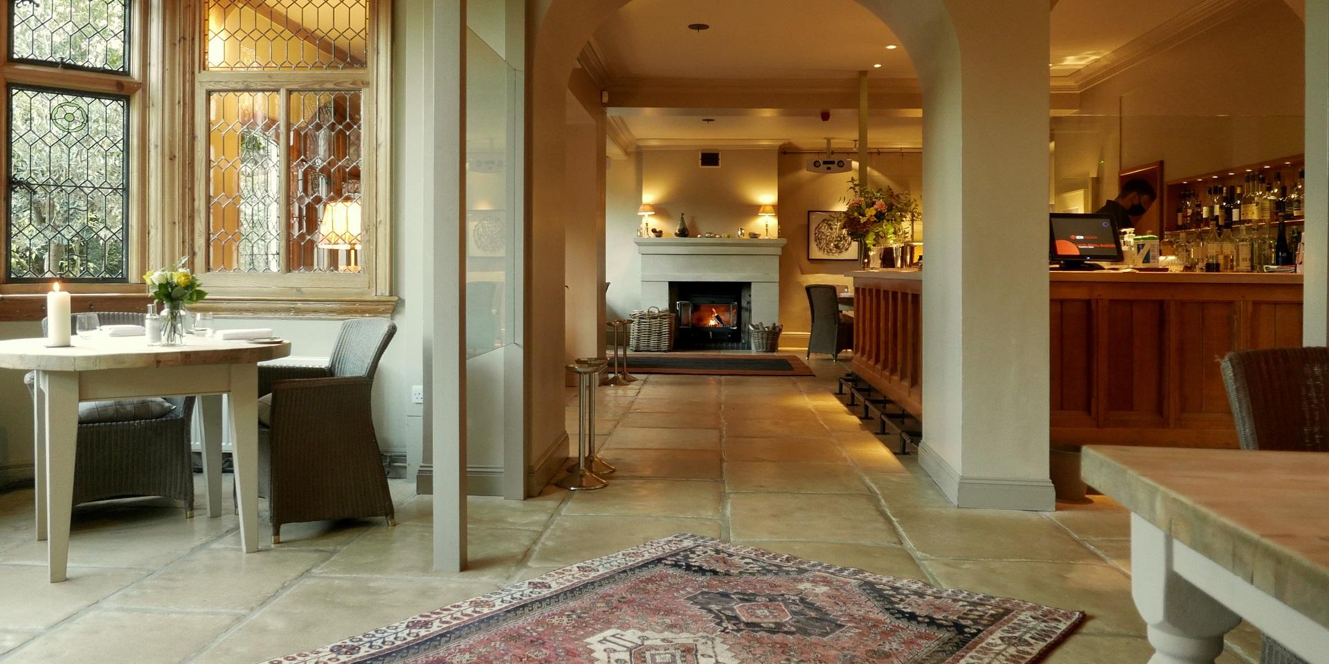 Welcoming Downstairs Dining Room with fireplace for intimate gatherings or networking events. - Banner