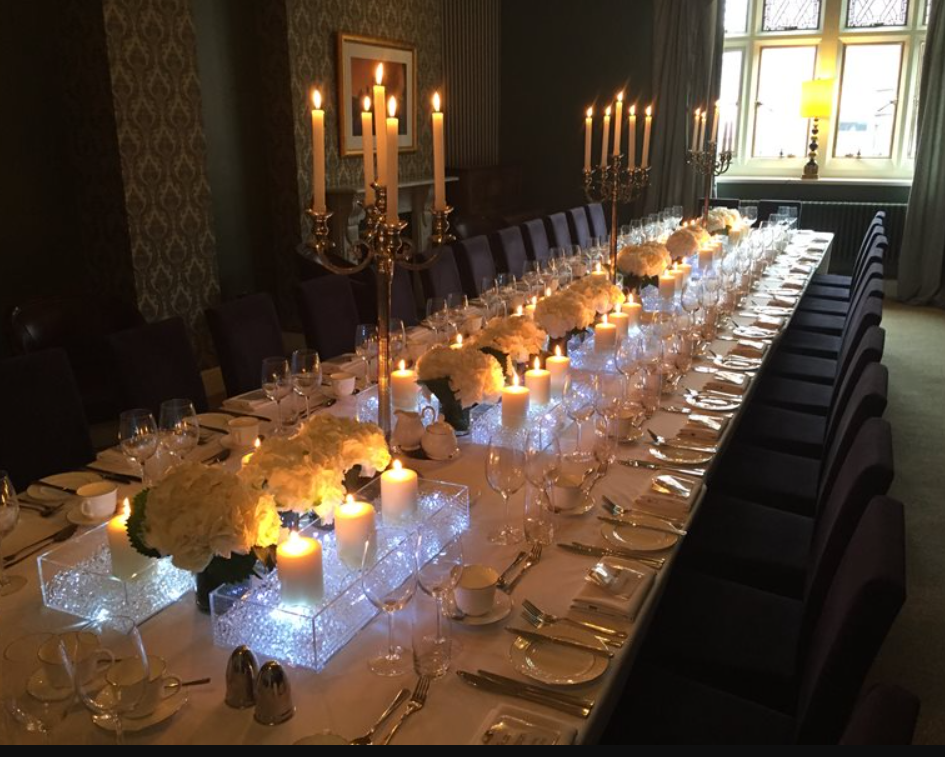 Elegant dining table with floral centerpieces for sophisticated events in Aspire Leeds. - Banner