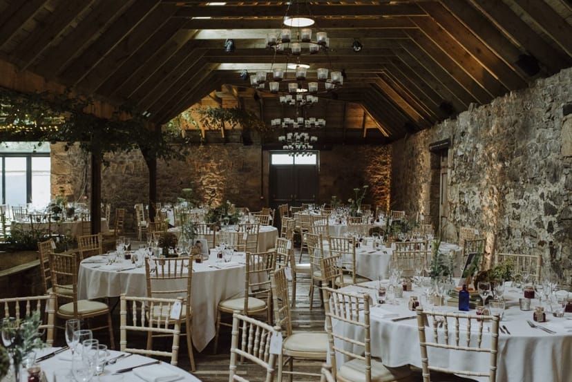 Whole Venue at The Byre: elegant round tables, rustic charm for weddings and gatherings.