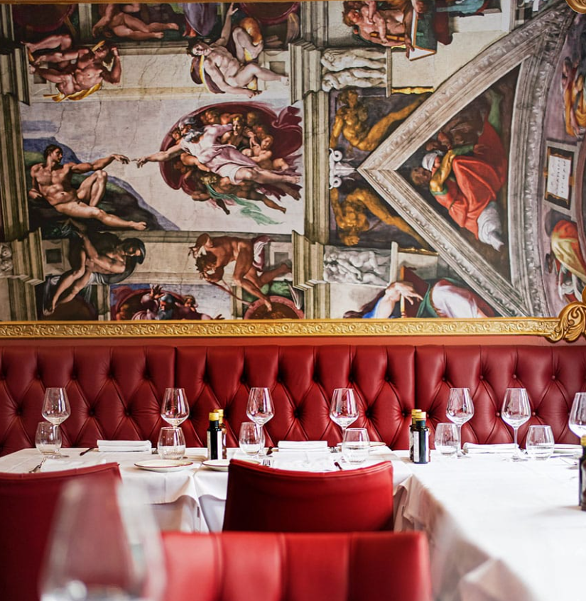 Elegant dining area with red banquettes in upscale San Pietro restaurant for events. - Banner