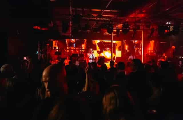 Guinness Open Gate Brewery event with dynamic stage, colorful lights, and engaged audience.