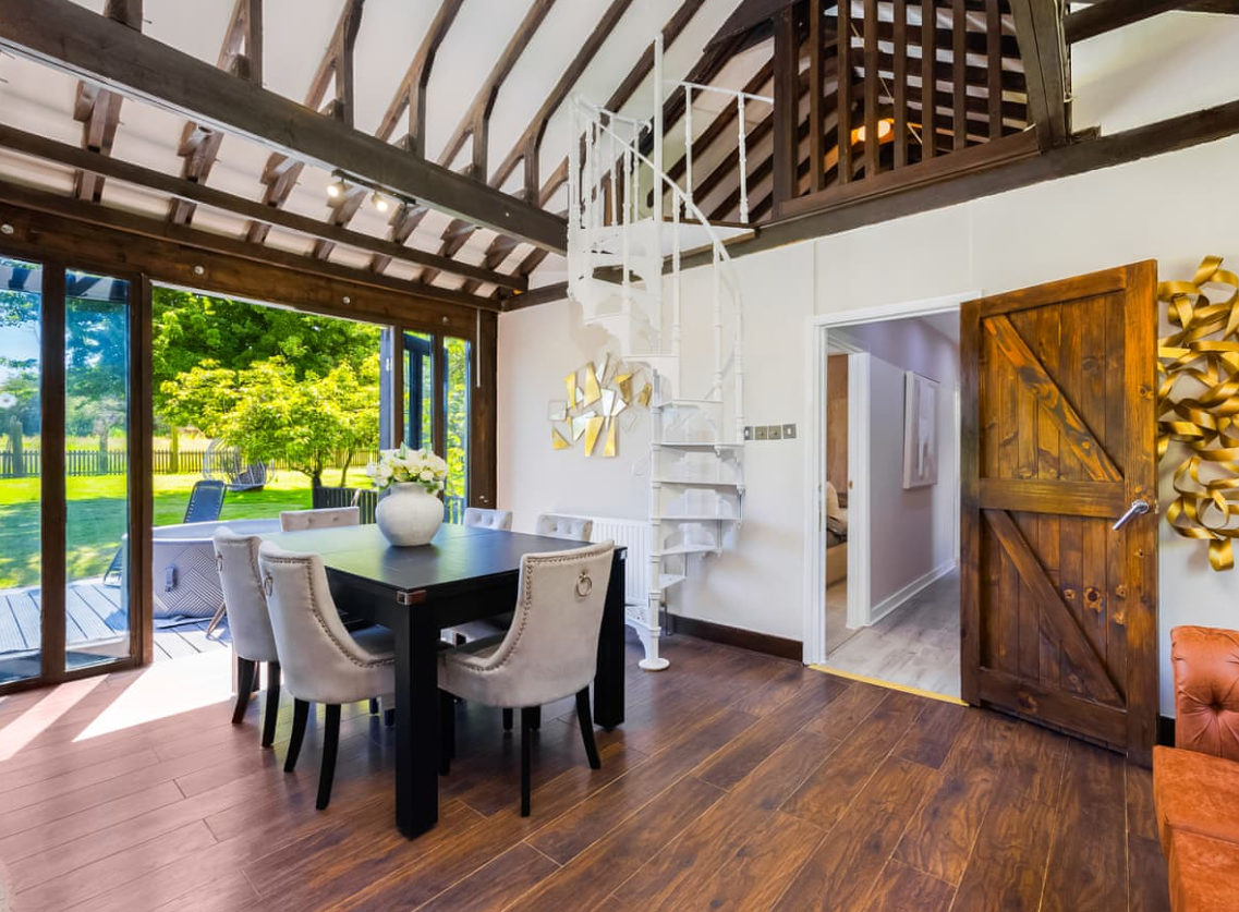 Essex Barn House: modern meeting space with large windows, perfect for corporate events.