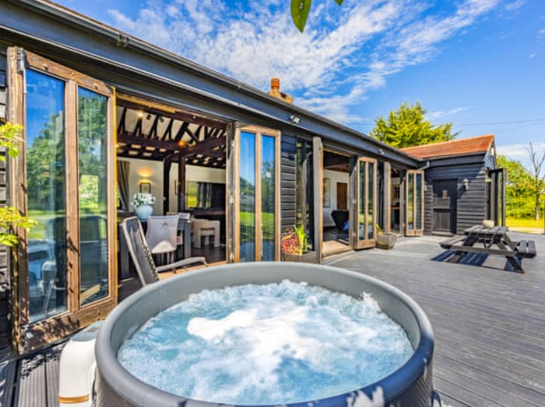 Essex Barn House outdoor space with hot tub, ideal for retreats and gatherings. - Banner
