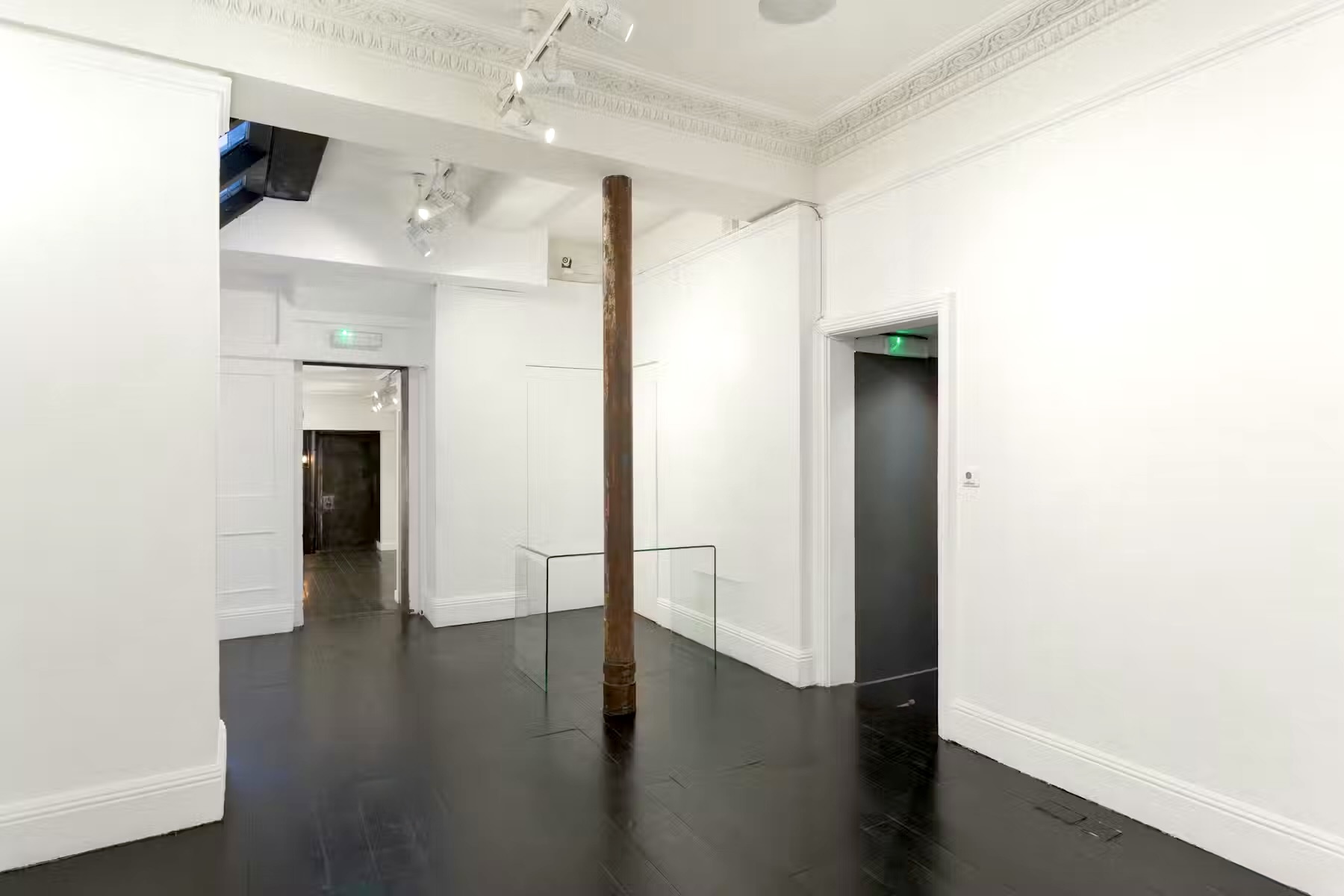 Minimalist gallery at 15 Bateman Street Soho with polished floors; perfect for events. - Banner