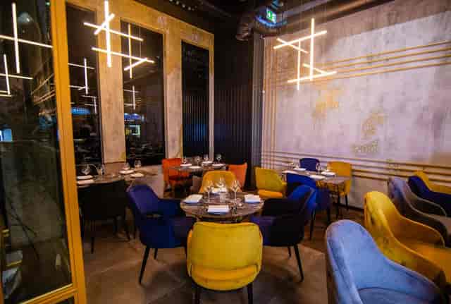 Modern dining area with vibrant chairs, ideal for upscale events and receptions.