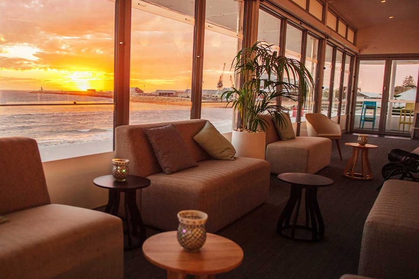 Modern Bathers Beach House VIP lounge with sunset views for corporate events and networking.