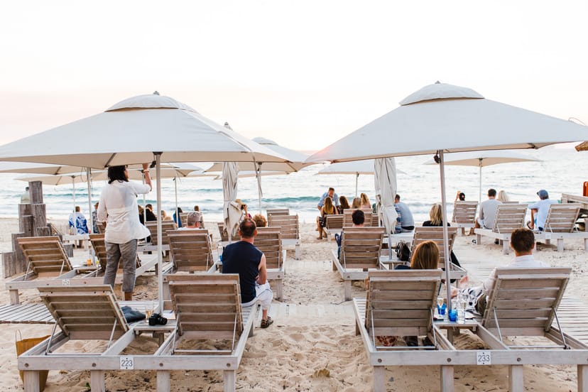 Beachside breakout session with relaxed seating for corporate events and networking.