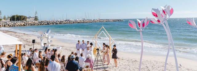 Coastal wedding ceremony with geometric altar at Bathers Beach House for beach event decor.