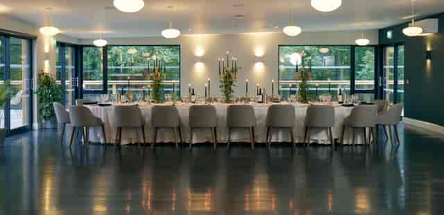 Elegant banquet table in modern venue for intimate gatherings or corporate events.