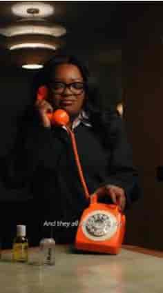 Meeting professional with orange phone coordinating logistics in Consultridge venue.