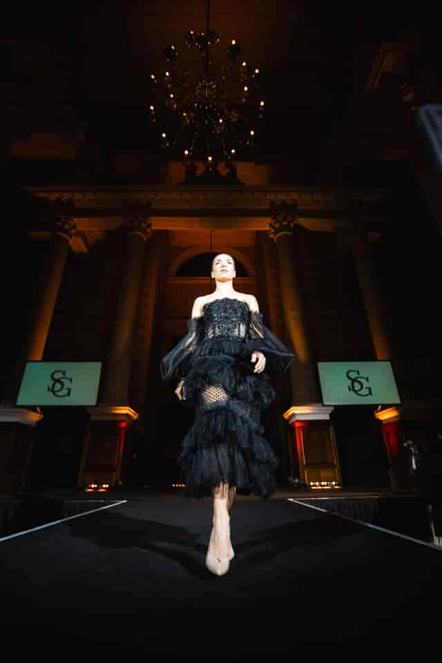 Gala event at The Nave Spitalfields with dramatic uplighting and dual branding screens.