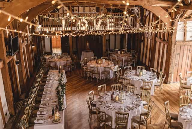 Exclusive hire event space in The Tudor Barn with rustic wooden beams, ideal for weddings.