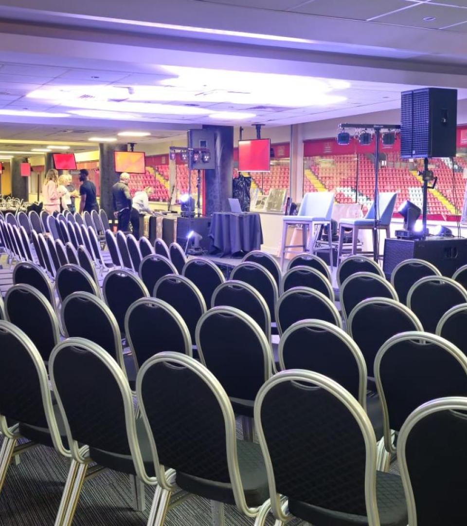 Vice President's Lounge at Charlton Athletic, ideal for meetings and events with elevated stage. - Banner
