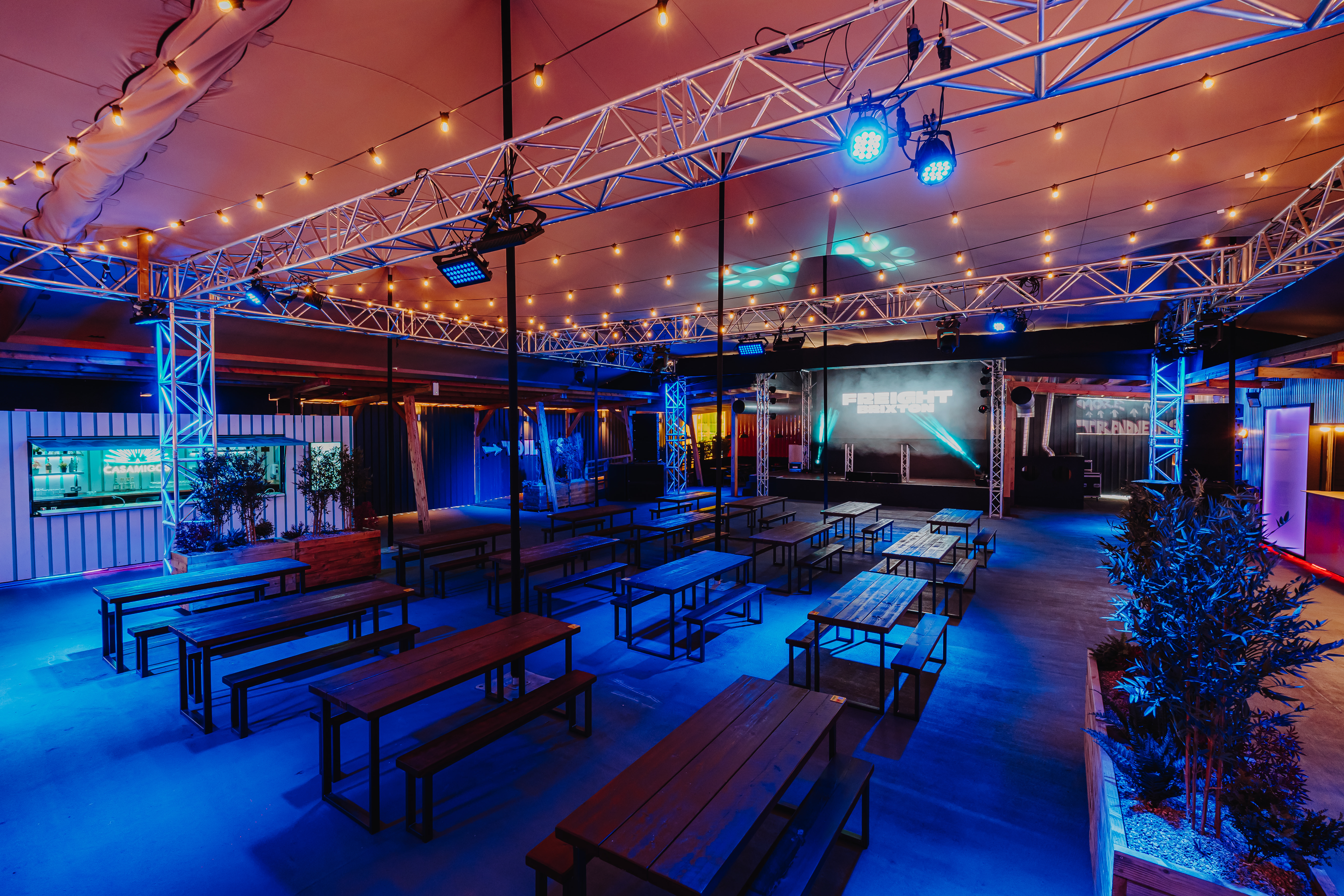 Industrial-chic event space with modular seating for networking and corporate activations. - Banner