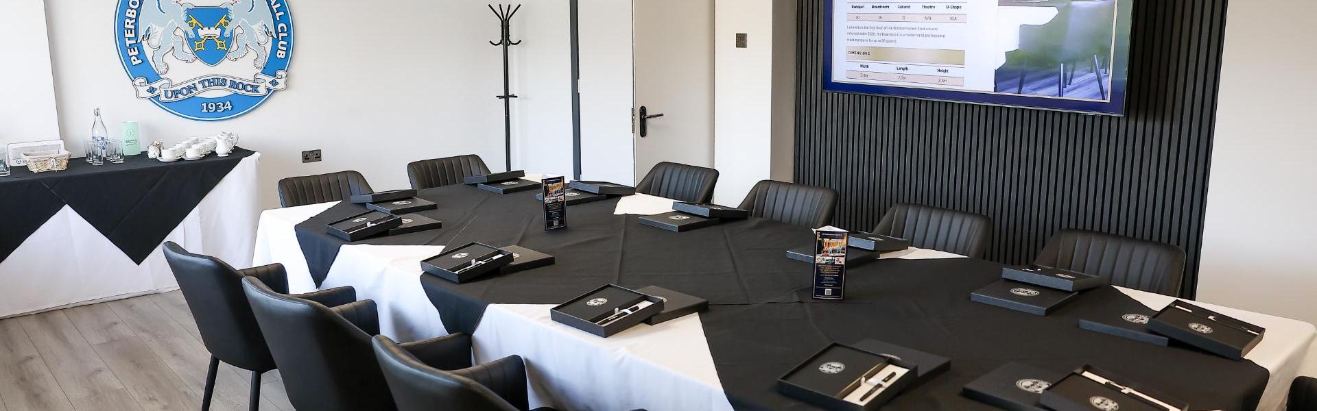 Modern boardroom setup for professional conferences with sleek decor and branded materials.