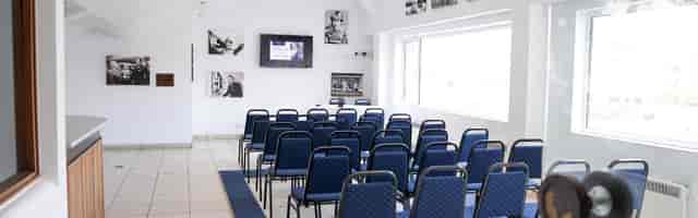 David Seaman Suite at Peterborough United FC: modern meeting room with blue chairs, ideal for events.
