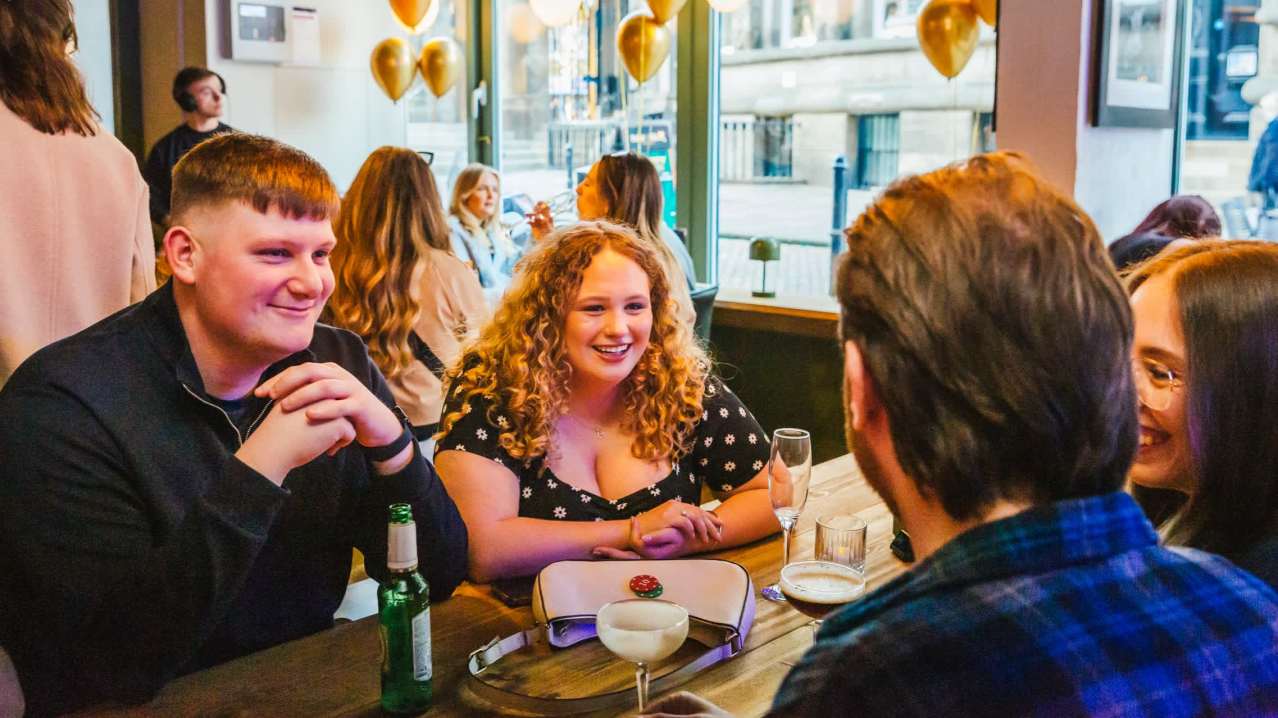 Leeds networking event: Golden balloons, communal table.