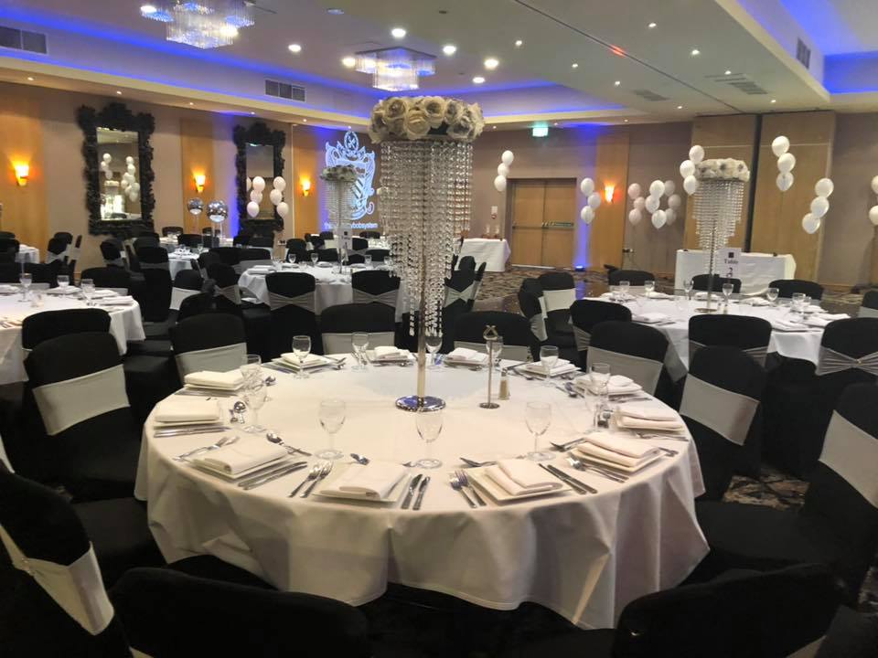 Elegant Merlot Suite banquet hall with white linens, perfect for weddings and events.